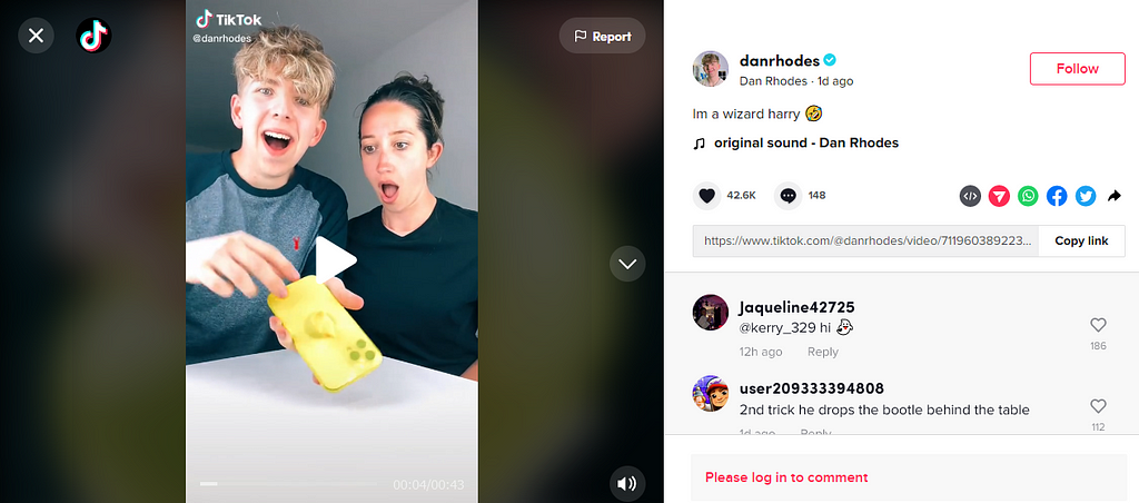 A screenshot of a TikTok showing a man (left) and a woman on his right. The woman has a shocked expression and is looking at the phone thatthe man is holding. The man is laughing and looking at the screen. The cellphone he is holding has a yellow balloon wrapped around it. The TikTok Video’s caption reads, “im a wizard harry” with a sideways laughing and crying emoji.