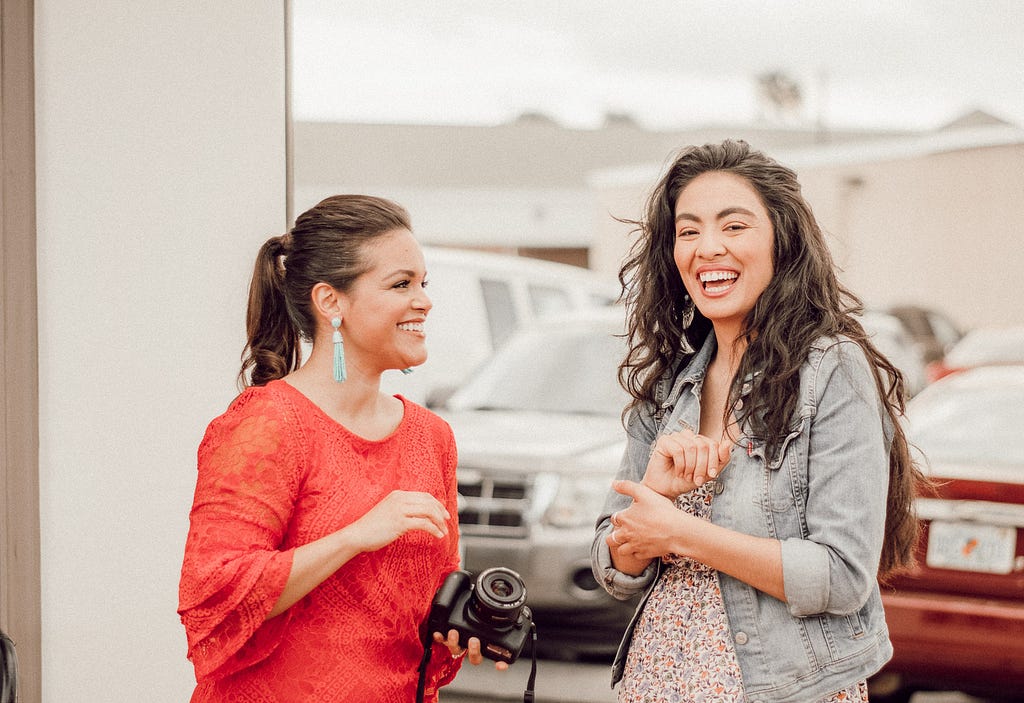 two Latinas laughing