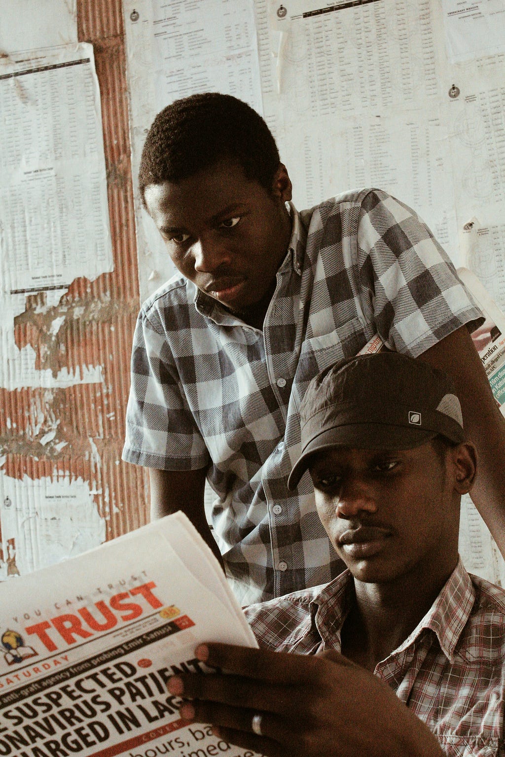 Young Nigerian Boys reading Local Newspapers