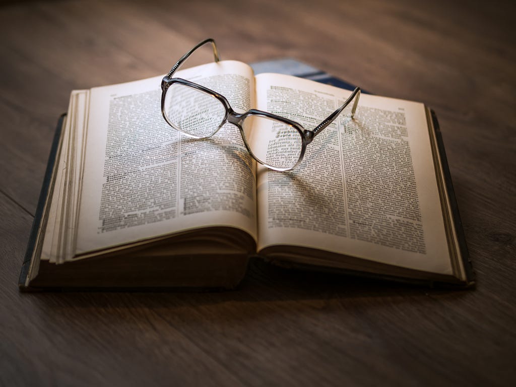 a photo of a pair of glasses sitting on an open book