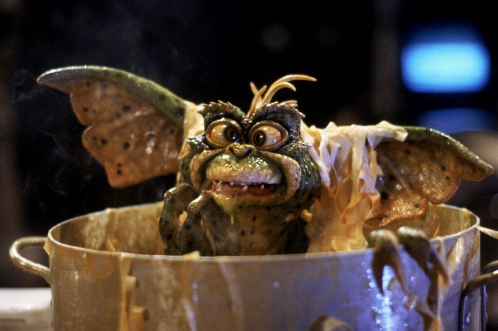 a gremlin comes out of a food pot in Gremlins 2