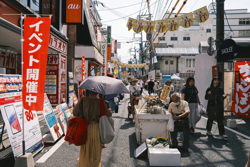 A small stand selling local foods in a shopping street.