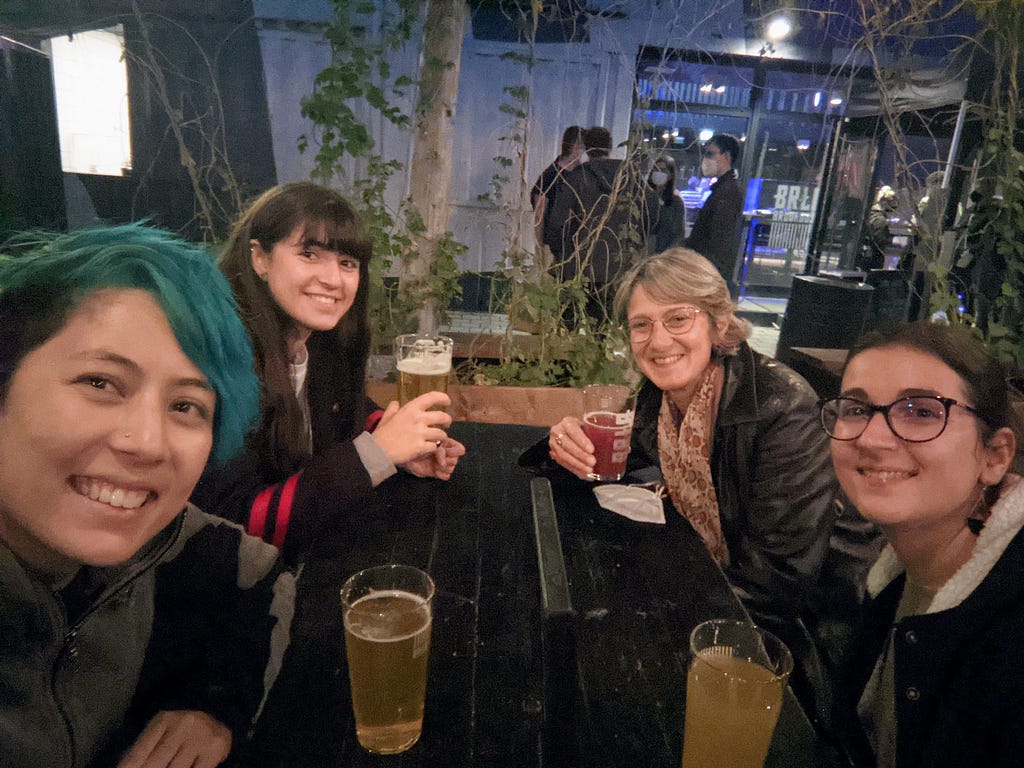 Author drinking beer with 3 other students in ages ranging from 17 to 50
