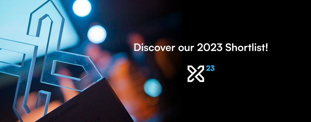 An Interaction Awards trophy is highlighted by a blue spotlight in the left foreground. The type ‘Discover our 2023 Shortlist’ and an Interaction Awards logo overlay the image on the right.
