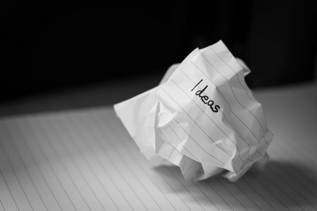 A rumpled paper with the word “ideas” written on it