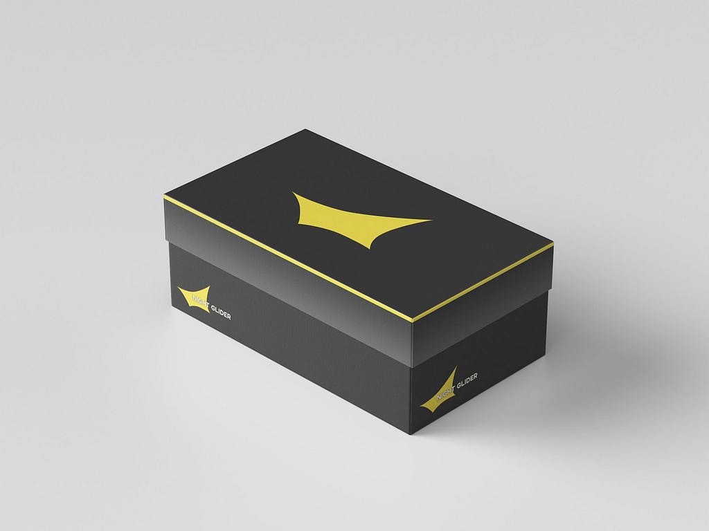 A mockup of a dark grey shoebox on a white background, with minimal yellow graphics on the box
