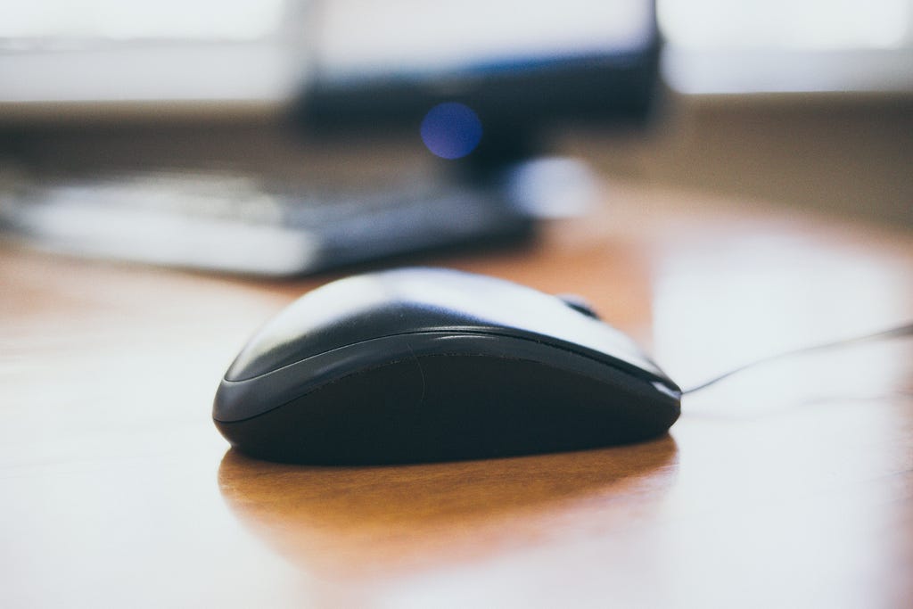 a photo of a computer mouse resting on a desk
