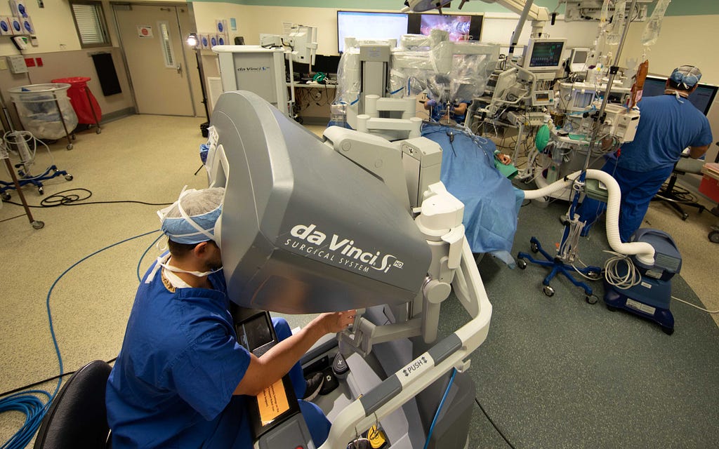 A doctor performing transoral robotic surgery on a patient