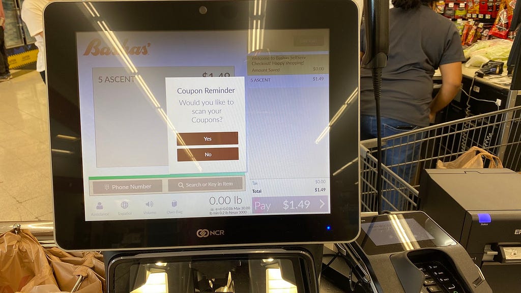 Self checkout machine from Bashas that asks if you would like to scan any coupons.