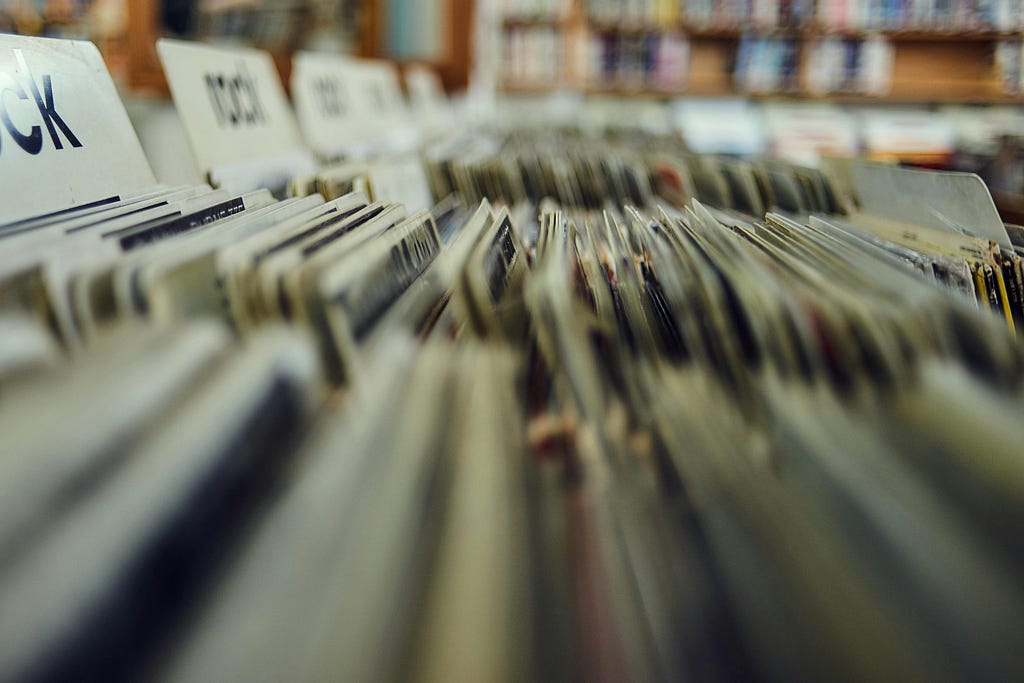 Records on a record store display.