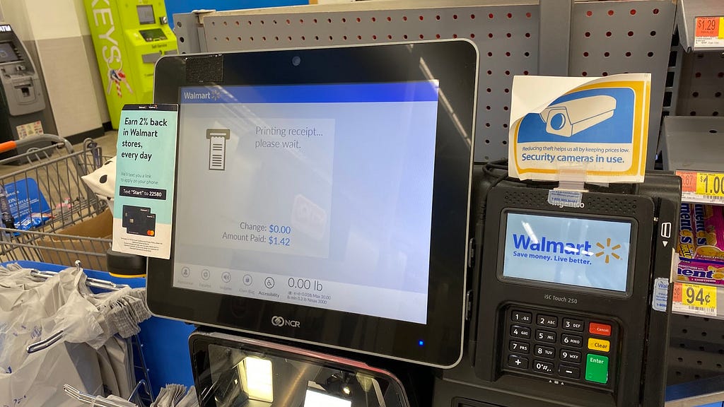 Self checkout machine from Walmart that reads printing receipt, please wait.