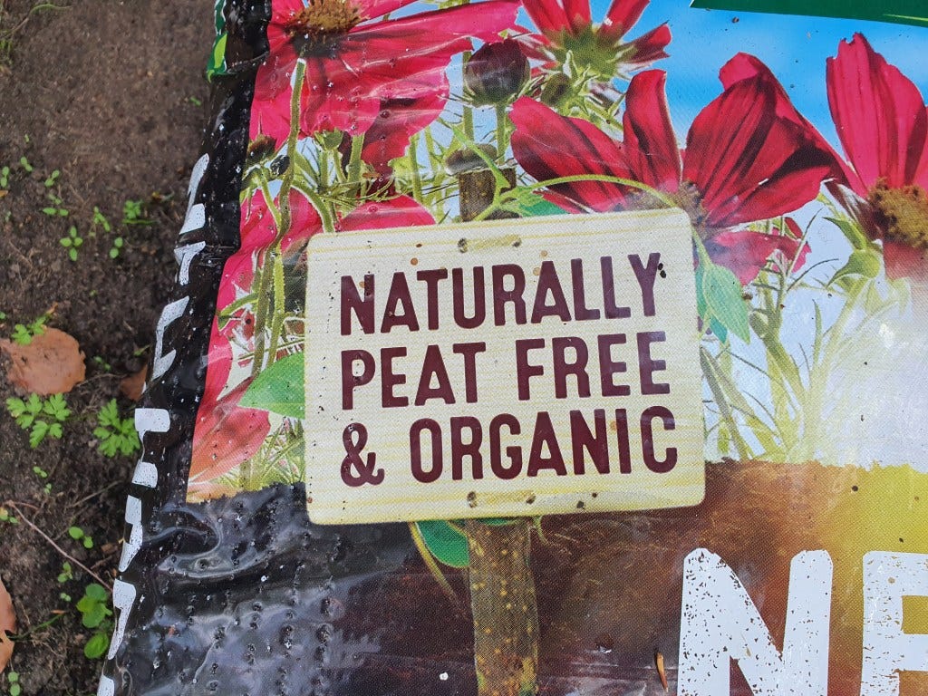 A compost bag with the words “Naturally peat free & organic” printed on it