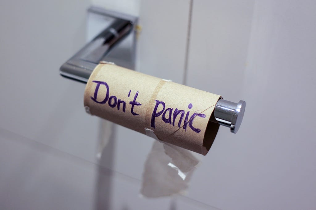 Picture of empty toilet paper roll that says “Don’t panic”