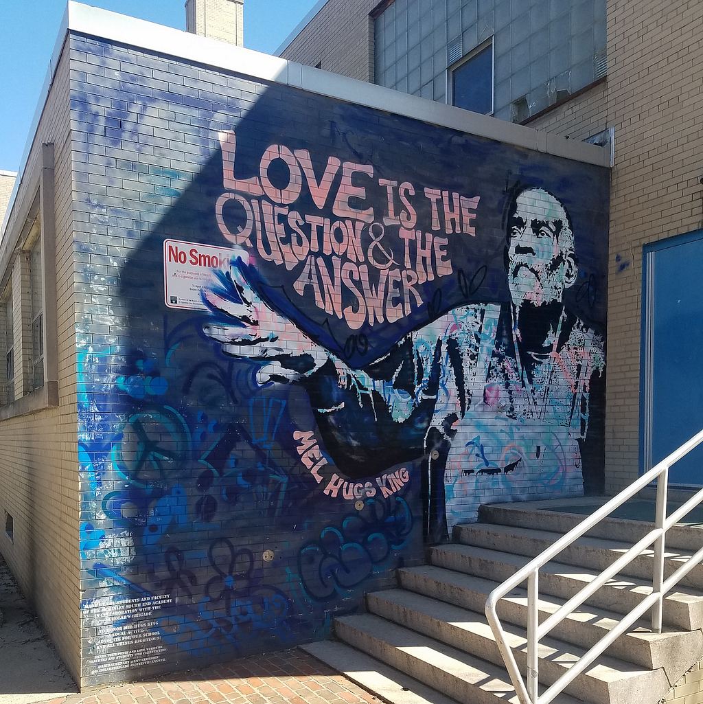 Photo of a mural at the Mel King Academy building in the South End showing Mel King and the slogan, “Love is the question and the answer.”