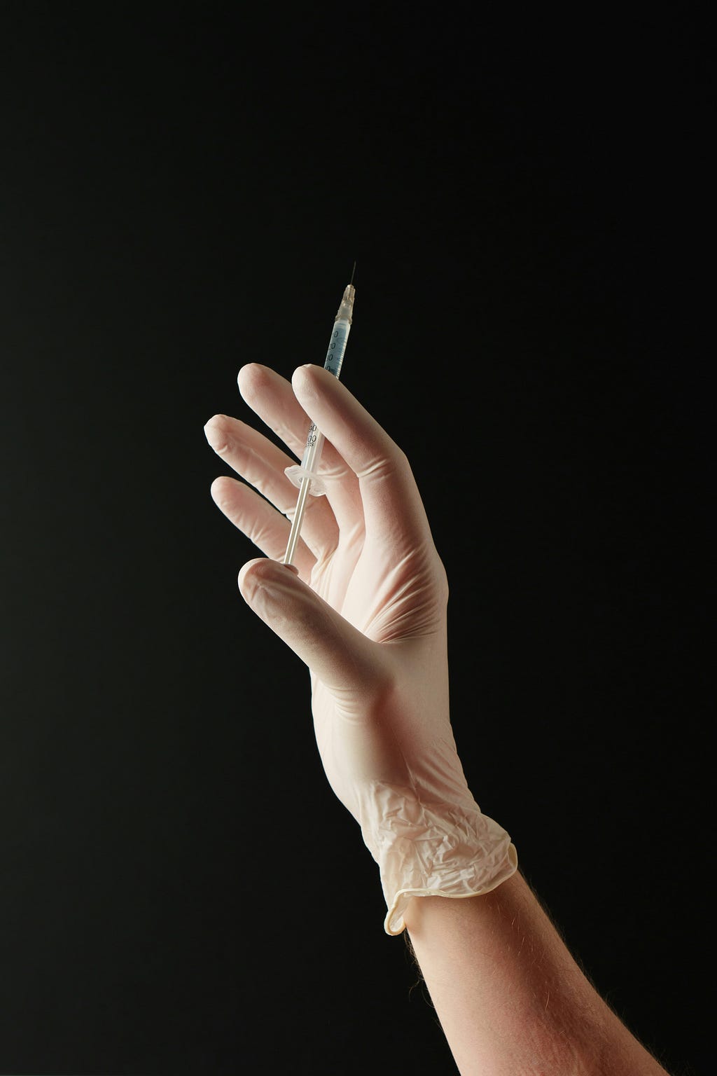 An image of a medical professional, syringe in hand, preparing to administer insulin on a potential patient.