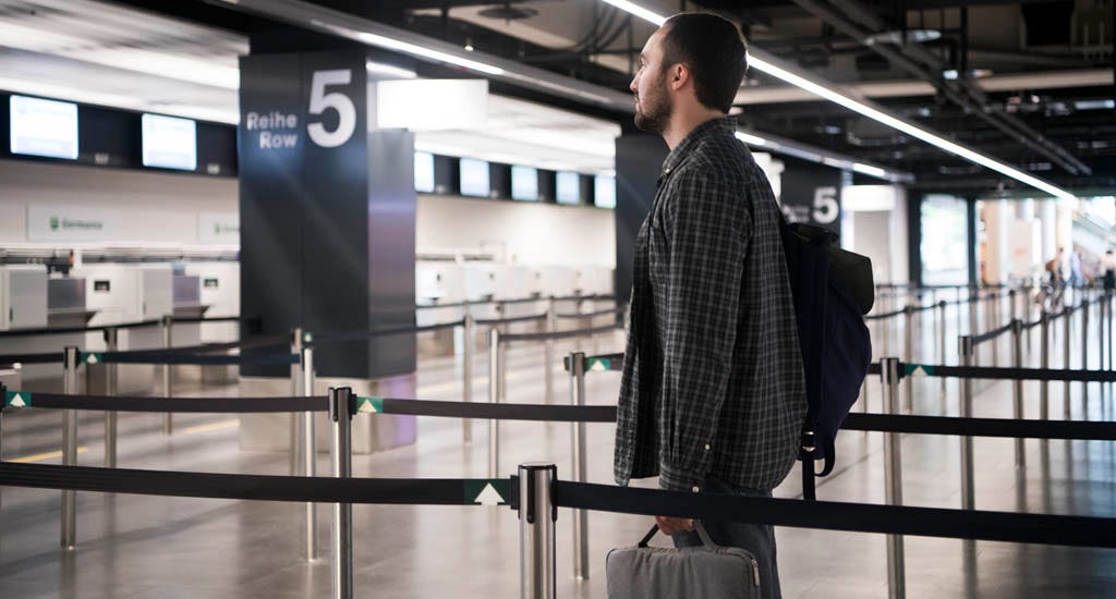 International college student entrepreneur standing in empty airport
