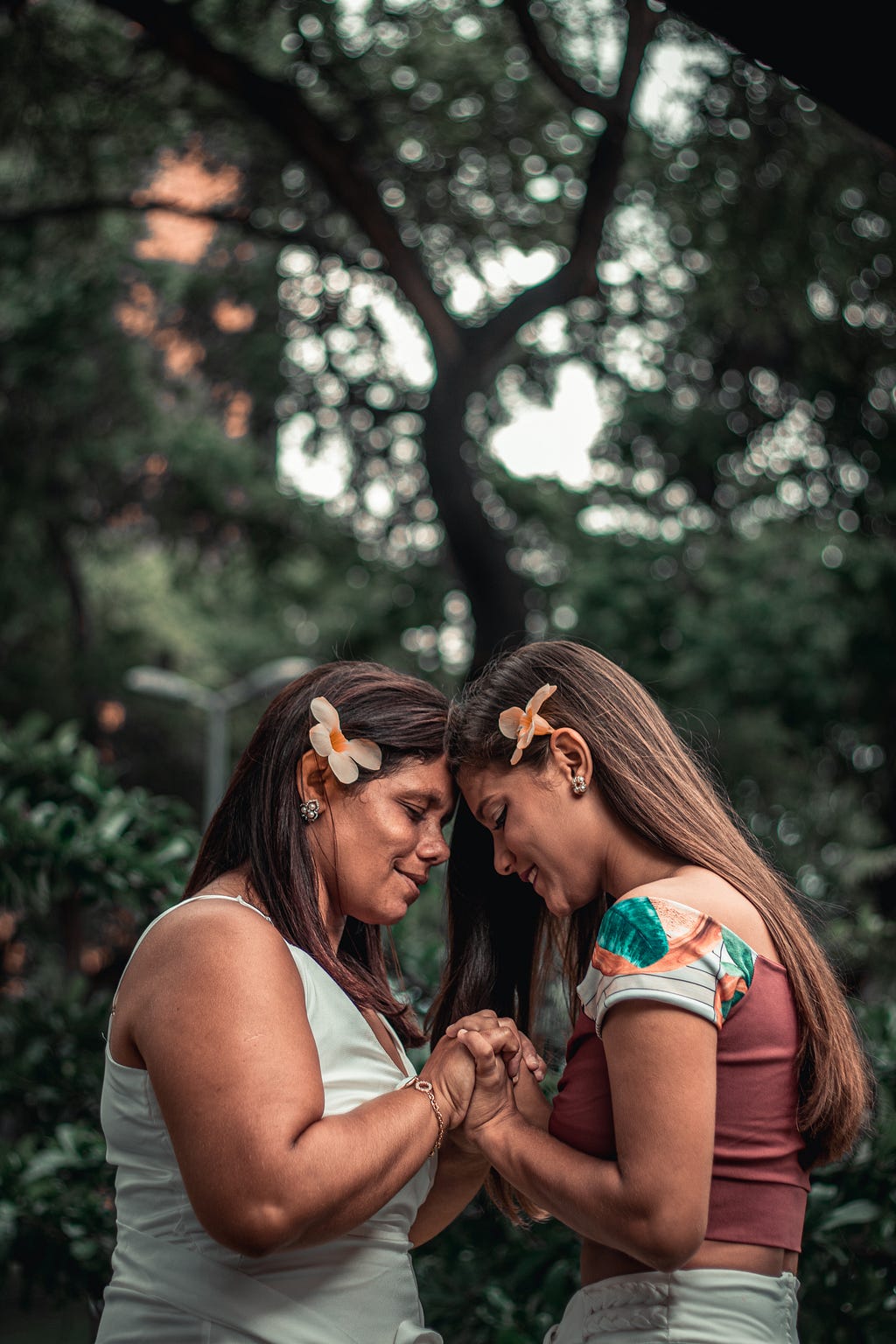 Image of two women — a mother and a daughter holding hands.