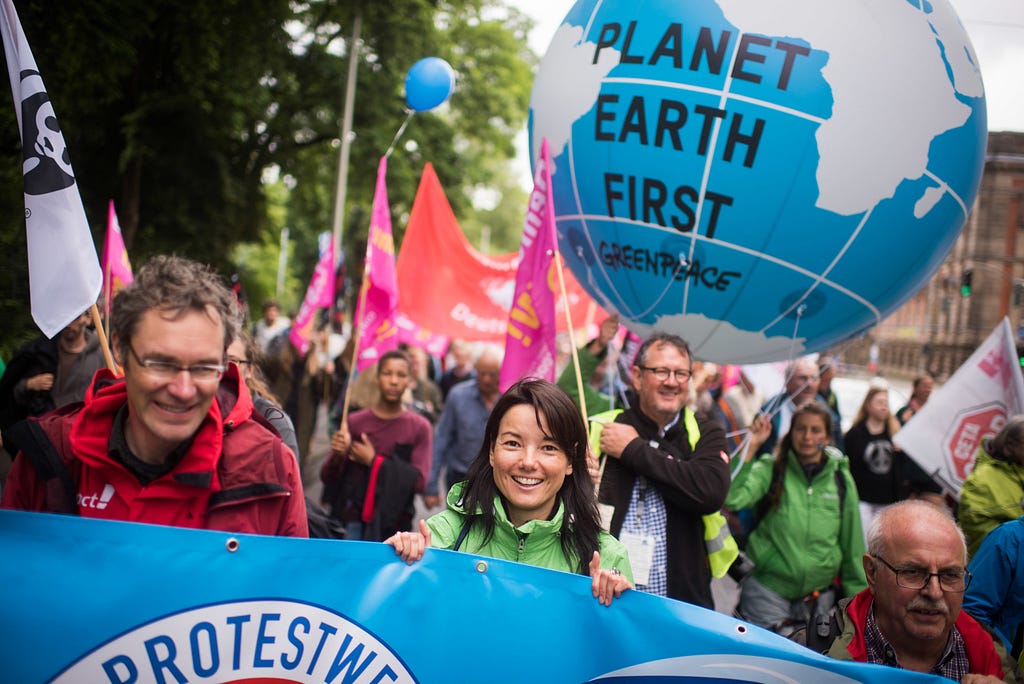 Plane Earth First Greenpeace sign https://images.app.goo.gl/n1m3hHZ4vDQFmX7S8