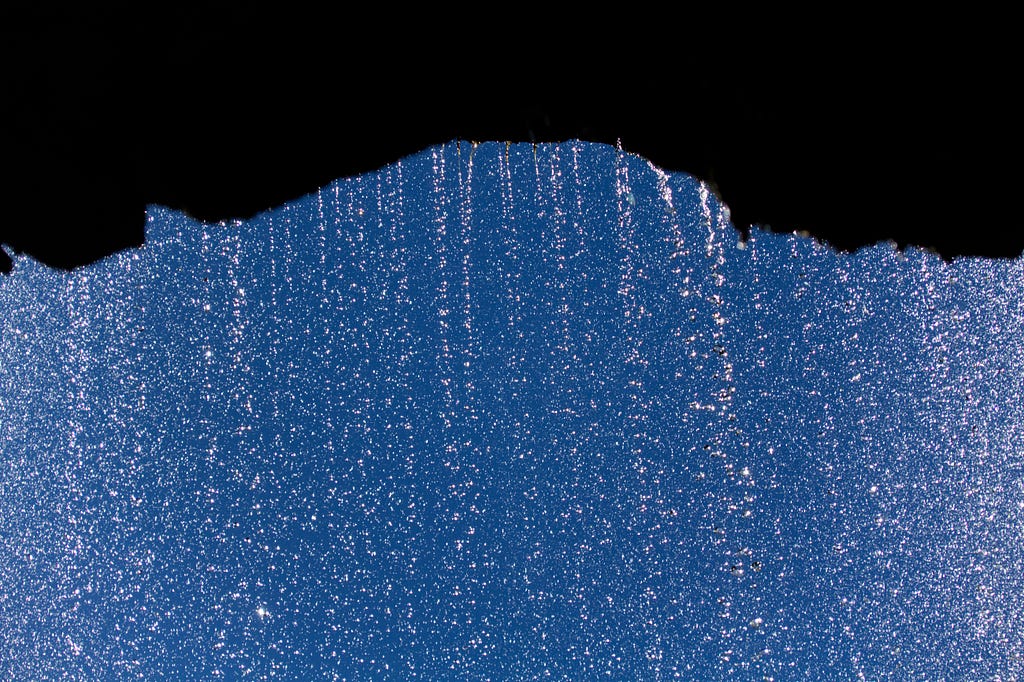 rainwater dripping heavily from an overhanging cliff