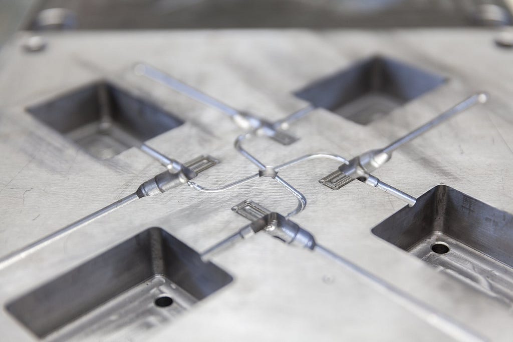 A steel mold precisely made to recreate the same plastic piece thousands of times over. Molds are an essential part of plastic injection molding