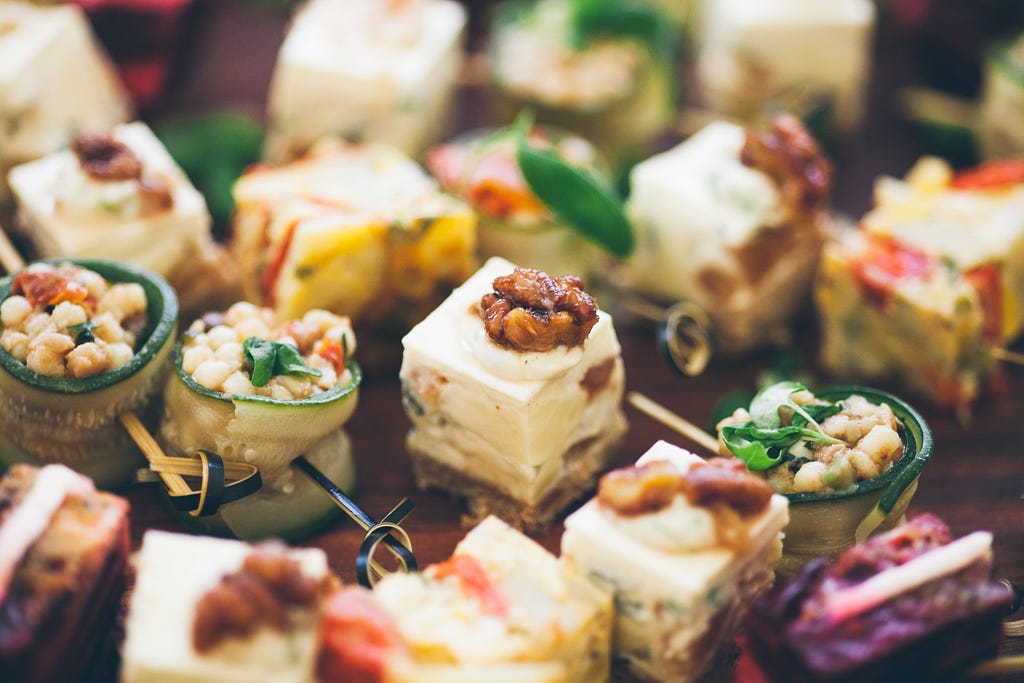 A photograph of canapes on a buffet table.