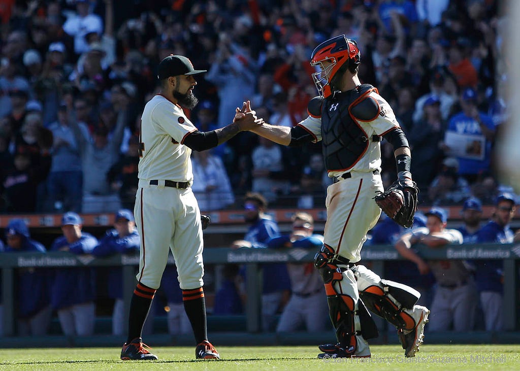 Sergio Romo and Buster Posey celebrate after the final out of the ninth inning.