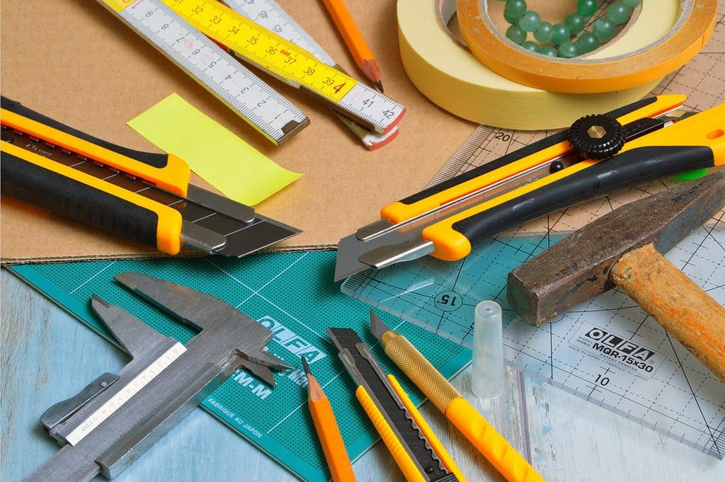 Image of a variety of tools for measuring, cutting, drawing