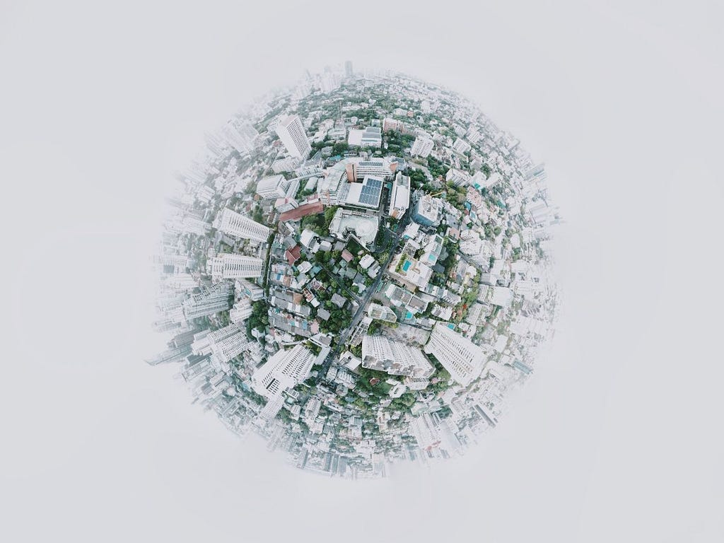 A fish-eye view of a small, circular world with a lot of buildings