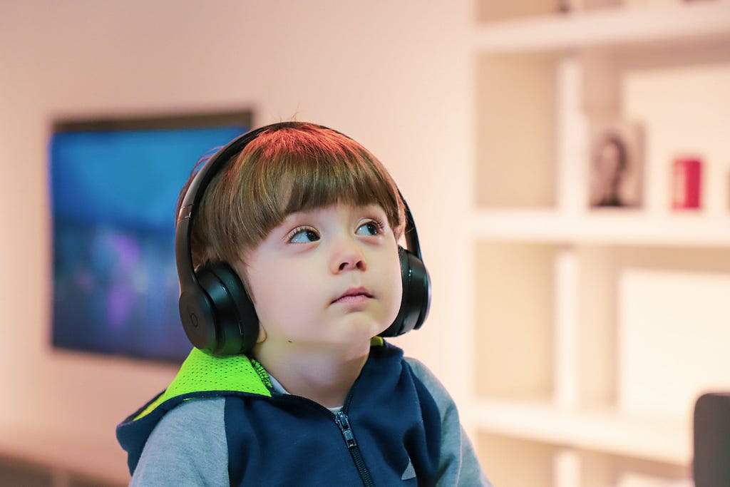 Young child wearing oversized bose headphones