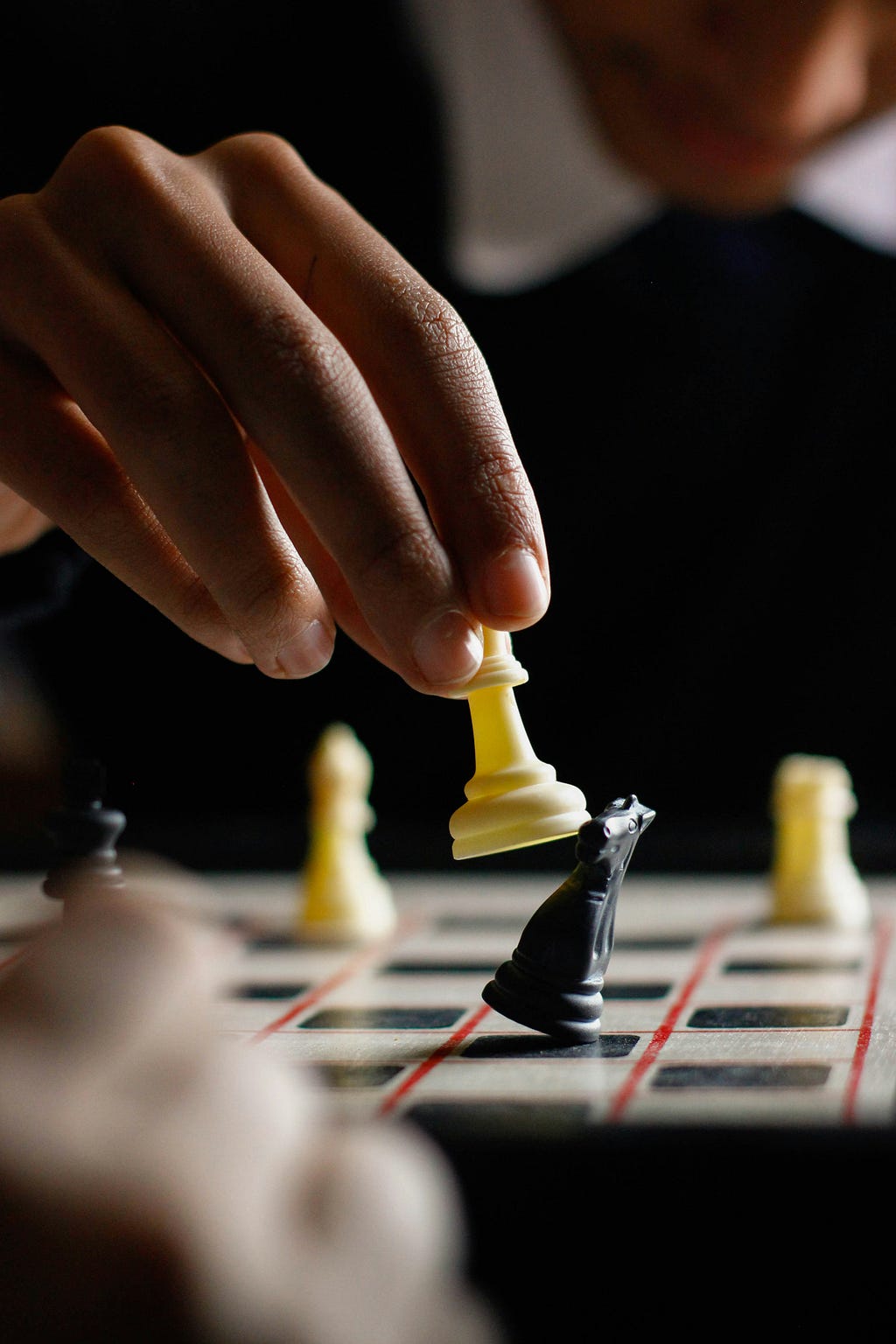 Chess candidate triumphing over opponent in tournament match.