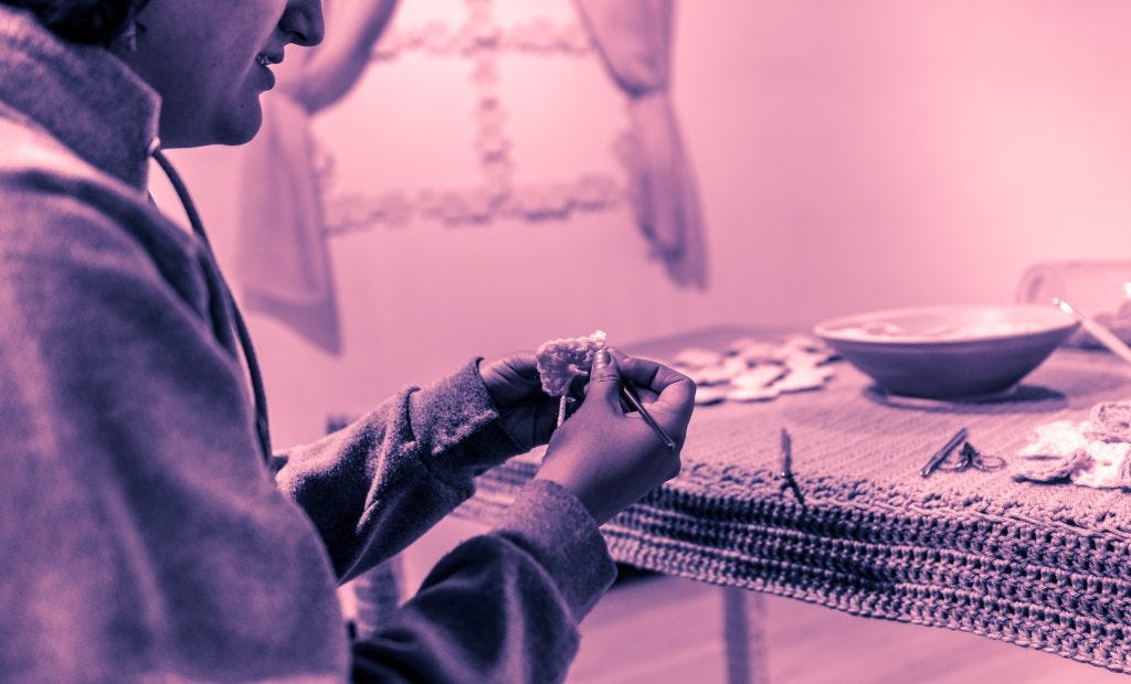 detail of Claudia V. Solorzano's hands crocheting a small heart