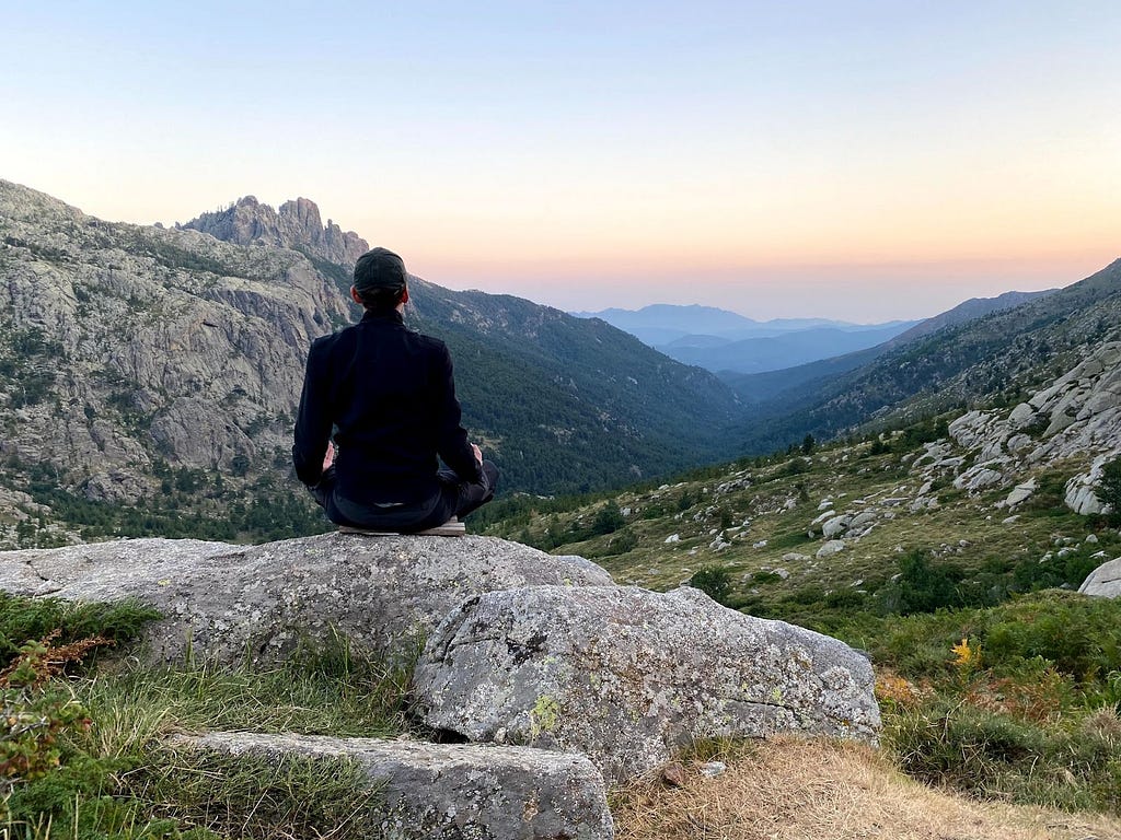 Man meditating in the mountains