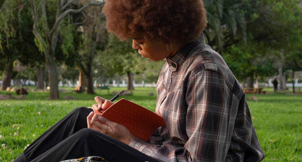 Writer developing brand ideas in park