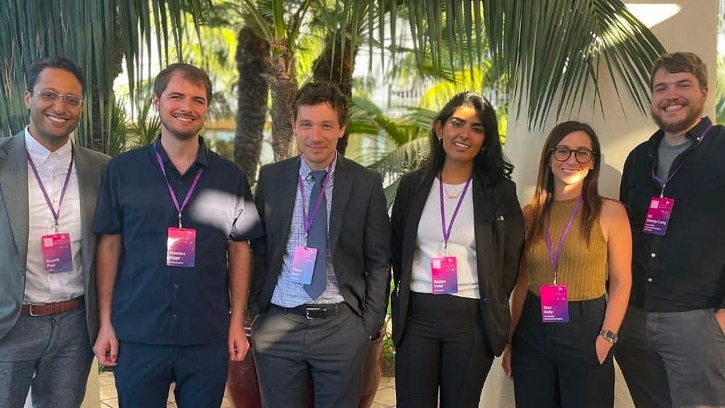 A photo of 6 members of the Remarkable Disability Tech Accelerator Program in front of palm trees