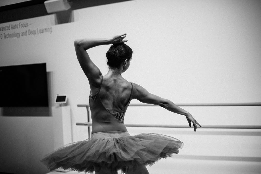 The defined muscles of a female ballerina’s back.