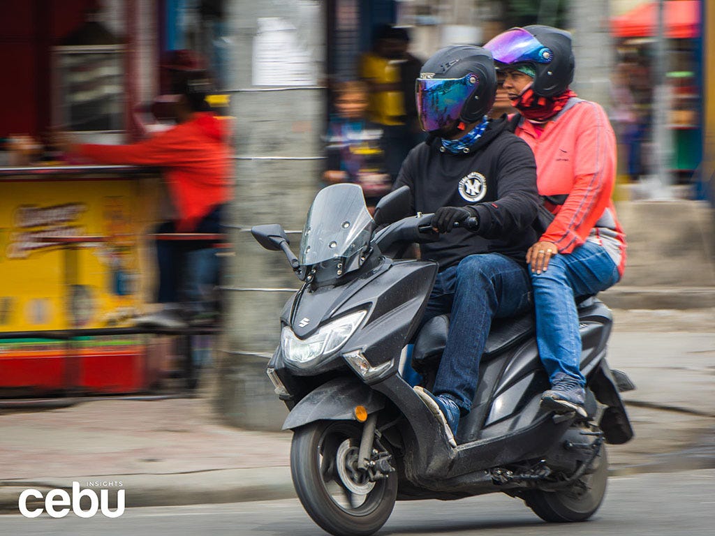 Man carrying a passenger on a motorycle