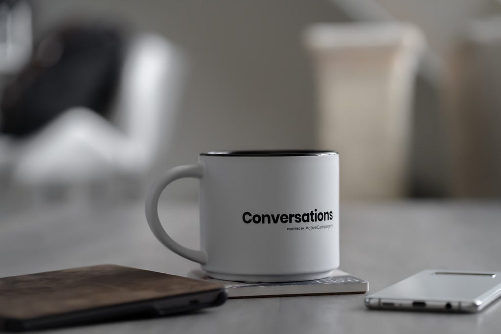 white mug with the word conversation written on it