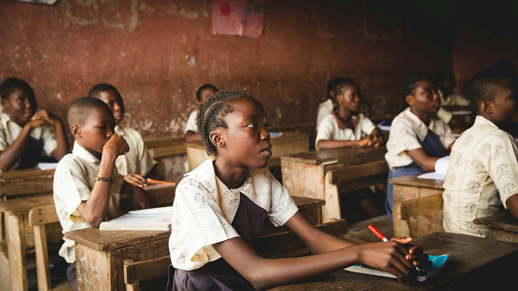 Nigerian students learning in a dilapidated classroom