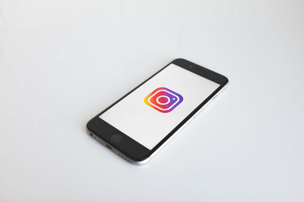 A photo of a phone with Instagram logo on the screen