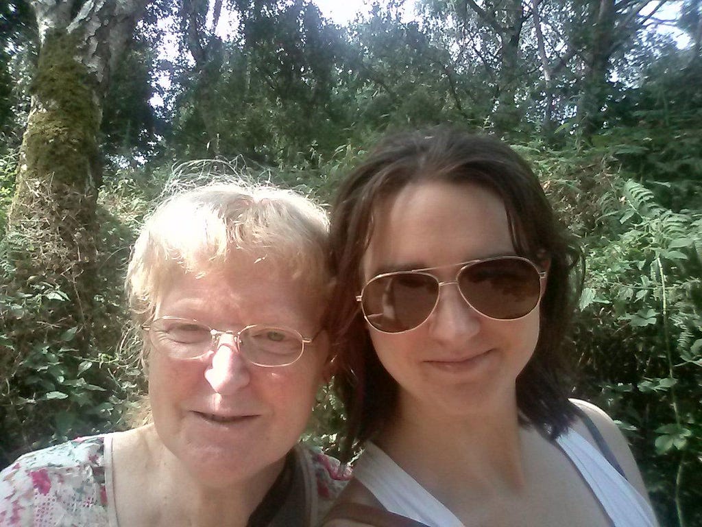 Hazel and her mother, Stephanie, standing in the sunshine in a wooded area