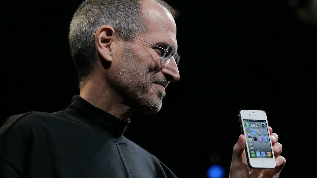 Steve Jobs reveals the iPhone 4 at a conference in 2010.