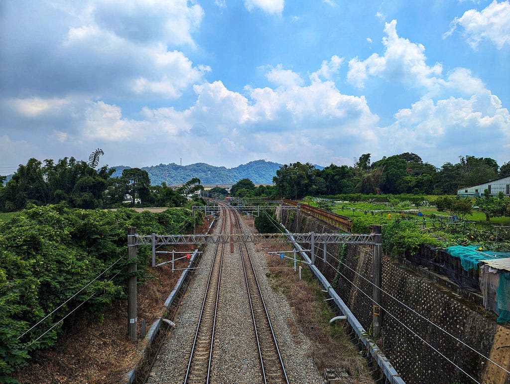 A railway line that heads towards the mountains in the north.