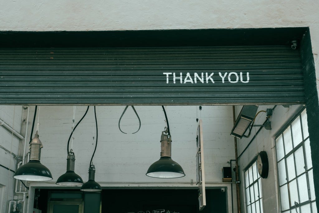 Garage door with "Thank You" painted on it.