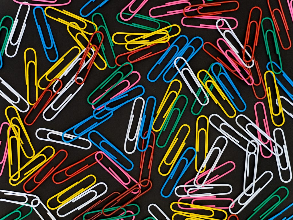 Colored paper clips spread out on a table