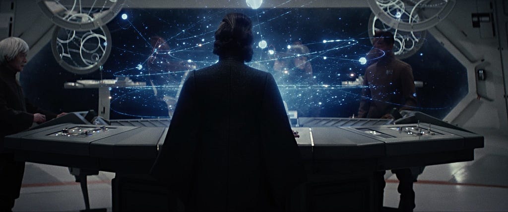 General Leia Organa faces away from the camera, pondering a star map and considering the next moves for the Resistance.