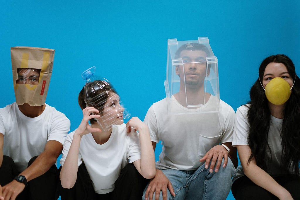 4 people having different objects on their heads.