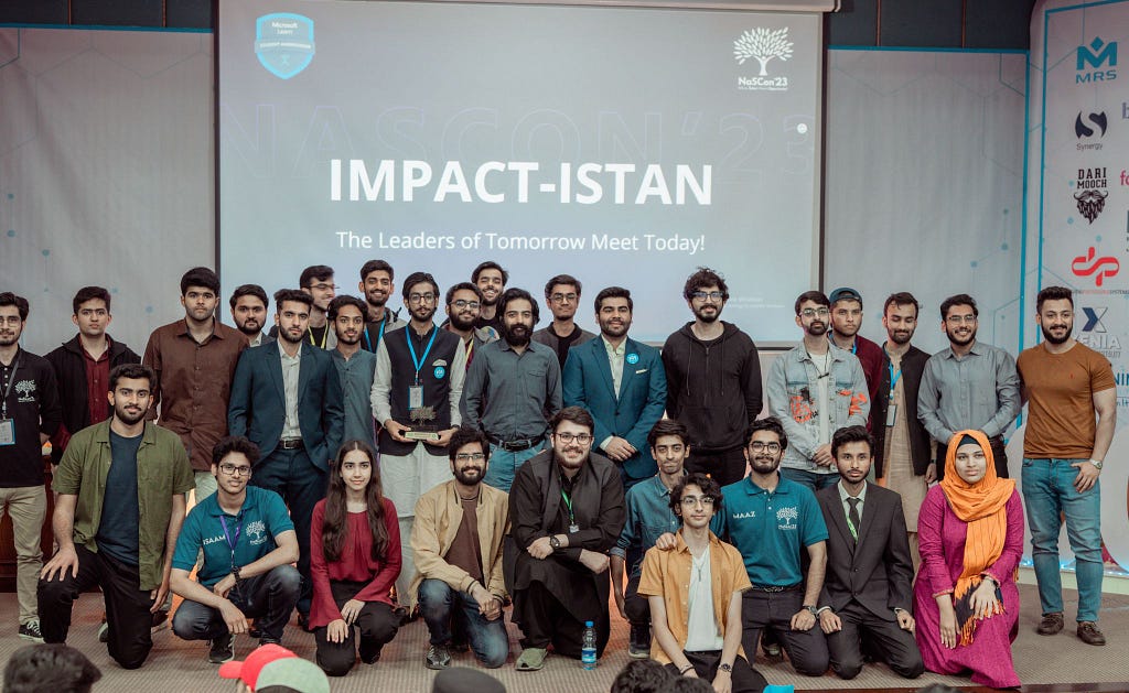 Umer Farooq, CTO MRS Technologies in a group photos with other students on the stage of the event known as Impactistan | Crappy Final Year Projects blog by Umer Farooq