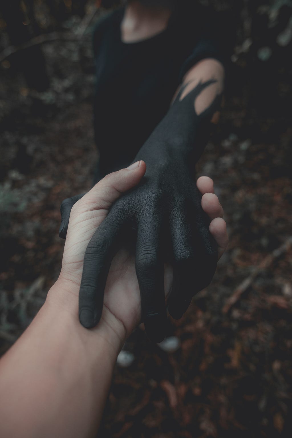 holding hands with dark colored hand, darkness, inner darkness, jealousy to others