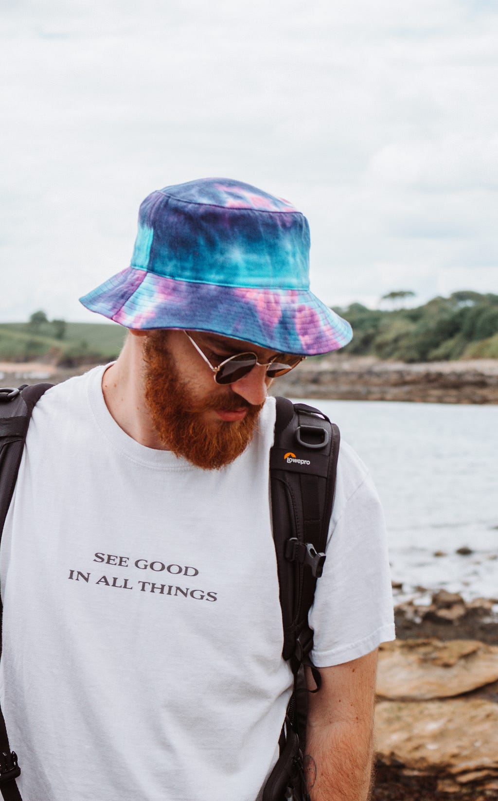 A man wearing a T-Shirt , with the wordings “See good in all things”