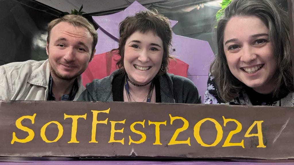 Three people pose with a sign that says SoTFest2024. They are all smiling and having a great time.